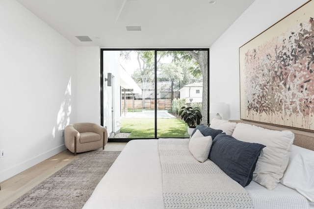 2701 Greenlee Dr, Austin, TX 78703 - bedroom with access to exterior, wood finished floors, and a wall of windows