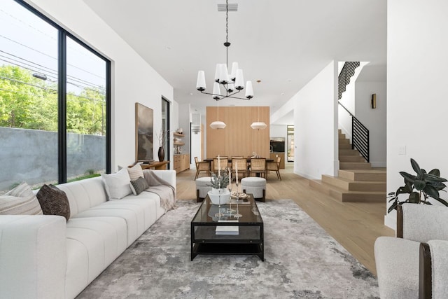2701 Greenlee Dr, Austin, TX 78703 - living area with a chandelier, wood finished floors, and stairway