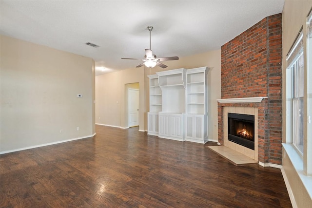 1008 NE Chippewa St, Round Rock, TX 78665 - unfurnished living room featuring a ceiling fan, a brick fireplace, wood finished floors, and healthy amount of natural light