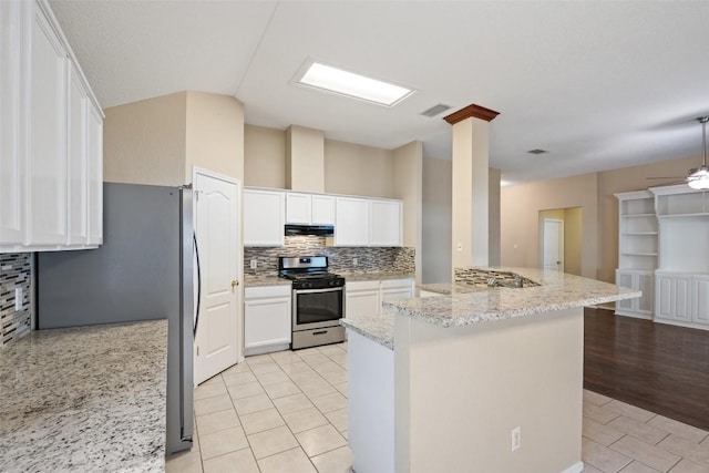 1008 NE Chippewa St, Round Rock, TX 78665 - kitchen featuring appliances with stainless steel finishes, under cabinet range hood, tasteful backsplash, white cabinetry, and light tile patterned flooring