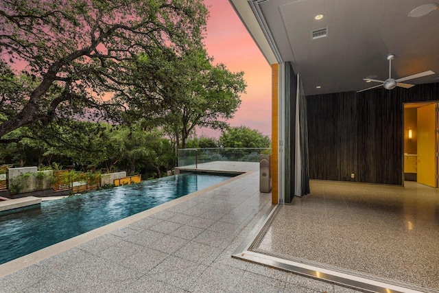 2505 Stratford Dr, Austin, TX 78746 - pool at dusk with ceiling fan, an infinity pool, and a patio area