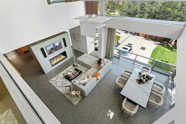 2505 Stratford Dr, Austin, TX 78746 - living room featuring a glass covered fireplace, plenty of natural light, and a towering ceiling