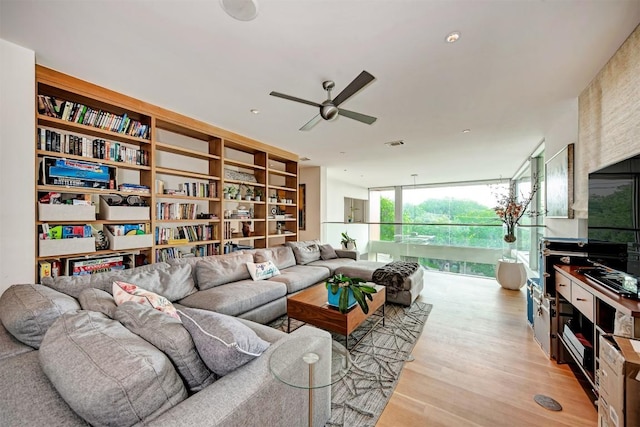2505 Stratford Dr, Austin, TX 78746 - living area with a ceiling fan, light wood-type flooring, and floor to ceiling windows