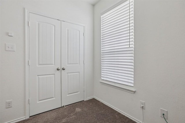 657 Bailey Park Dr, Jarrell, TX 76537 - unfurnished bedroom featuring dark colored carpet and a closet