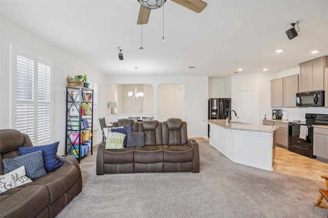 657 Bailey Park Dr, Jarrell, TX 76537 - living room with a chandelier, light colored carpet, recessed lighting, ceiling fan, and arched walkways