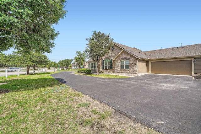 30 Wildwood Dr Unit 92, Georgetown, TX 78633 - view of front facade with driveway, stone siding, and an attached garage
