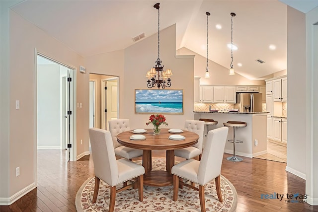 30 Wildwood Dr Unit 92, Georgetown, TX 78633 - dining room with light wood-style flooring, a chandelier, and high vaulted ceiling