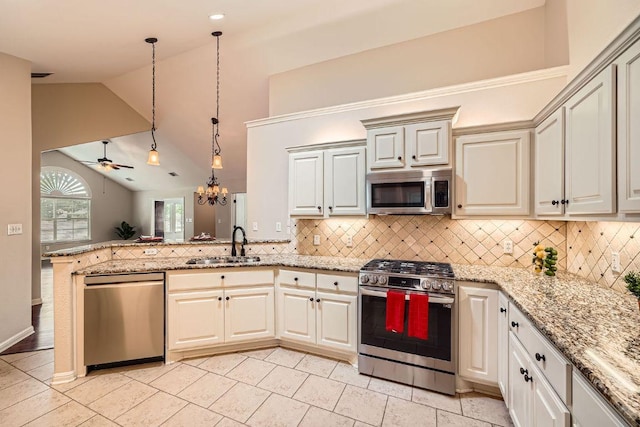 30 Wildwood Dr Unit 92, Georgetown, TX 78633 - kitchen featuring stainless steel appliances, lofted ceiling, decorative backsplash, a peninsula, and hanging light fixtures