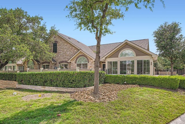 30 Wildwood Dr Unit 92, Georgetown, TX 78633 - back of property featuring stone siding and a yard