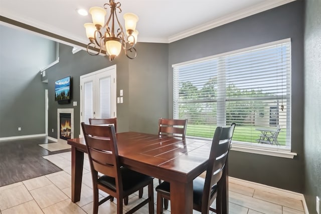 11611 Quarter Horse Trl, Austin, TX 78750 - dining area featuring a chandelier, healthy amount of natural light, ornamental molding, and a fireplace with flush hearth