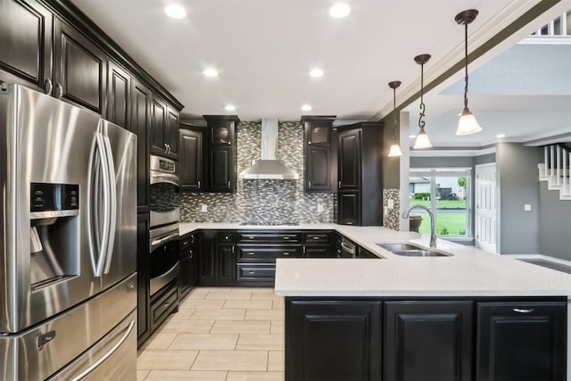 11611 Quarter Horse Trl, Austin, TX 78750 - kitchen featuring appliances with stainless steel finishes, wall chimney exhaust hood, backsplash, a peninsula, and dark cabinets