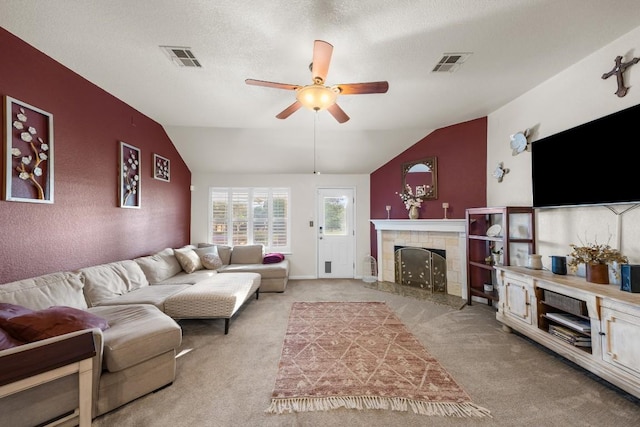 313 Polo Pony, Liberty Hill, TX 78642 - living room with lofted ceiling, a ceiling fan, light colored carpet, and a tile fireplace