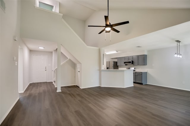 6900 Tesoro Trl, Austin, TX 78729 - unfurnished living room with high vaulted ceiling, dark wood finished floors, ceiling fan, and stairway
