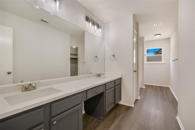 6900 Tesoro Trl, Austin, TX 78729 - bathroom featuring wood finished floors and double vanity