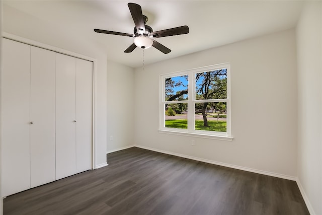 6900 Tesoro Trl, Austin, TX 78729 - unfurnished bedroom featuring dark wood-style flooring, a closet, and ceiling fan