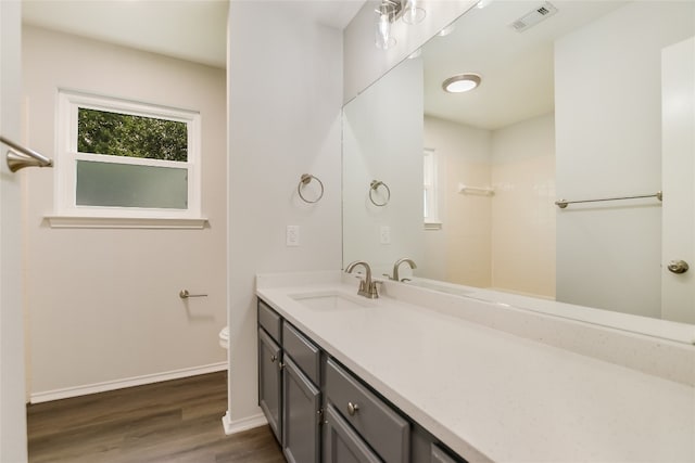 6900 Tesoro Trl, Austin, TX 78729 - bathroom with vanity, wood finished floors, and a tile shower