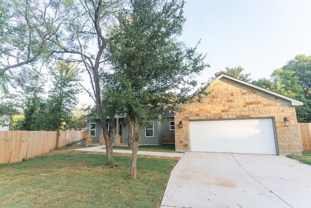 118 Kipapa Ct, Bastrop, TX 78602 - obstructed view of property with concrete driveway, an attached garage, and stone siding