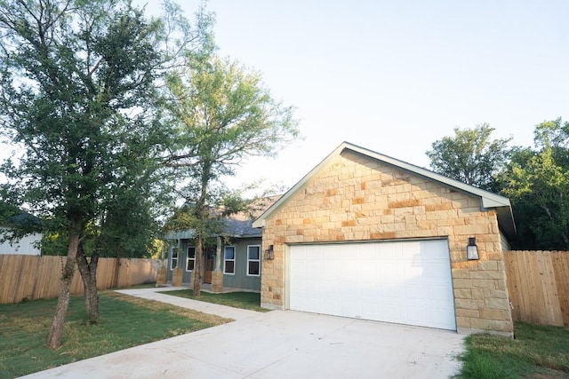 118 Kipapa Ct, Bastrop, TX 78602 - view of front of property with driveway, stone siding, and a garage
