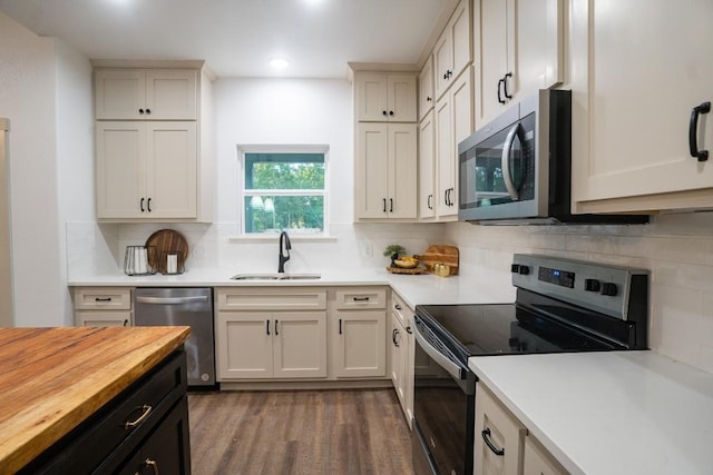 118 Kipapa Ct, Bastrop, TX 78602 - kitchen with appliances with stainless steel finishes, butcher block counters, wood finished floors, decorative backsplash, and recessed lighting