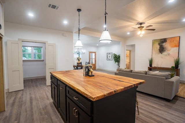 118 Kipapa Ct, Bastrop, TX 78602 - kitchen featuring butcher block countertops, dark wood-style flooring, dark cabinetry, and recessed lighting