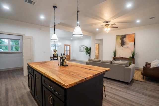 118 Kipapa Ct, Bastrop, TX 78602 - kitchen with wooden counters, dark wood-type flooring, dark cabinets, a center island, and recessed lighting