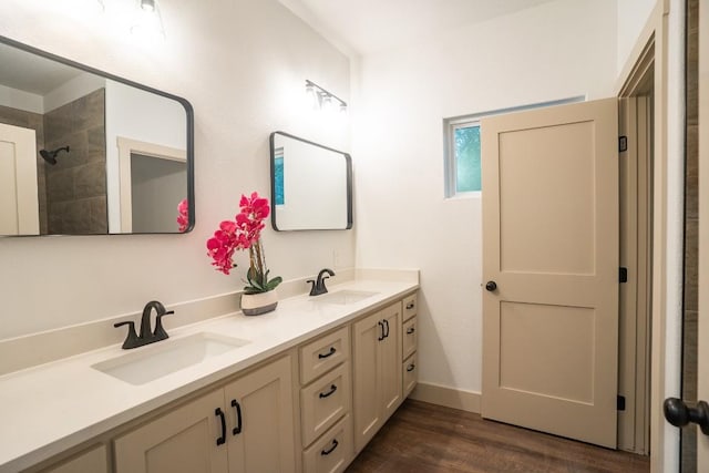 118 Kipapa Ct, Bastrop, TX 78602 - bathroom with double vanity, wood finished floors, and a tile shower