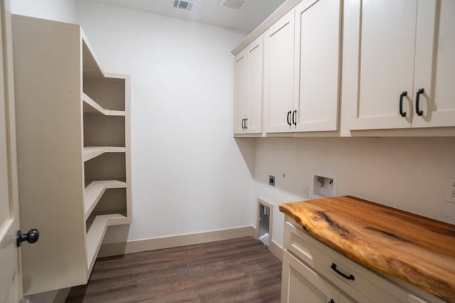 118 Kipapa Ct, Bastrop, TX 78602 - washroom featuring electric dryer hookup, cabinet space, washer hookup, and dark wood-style flooring