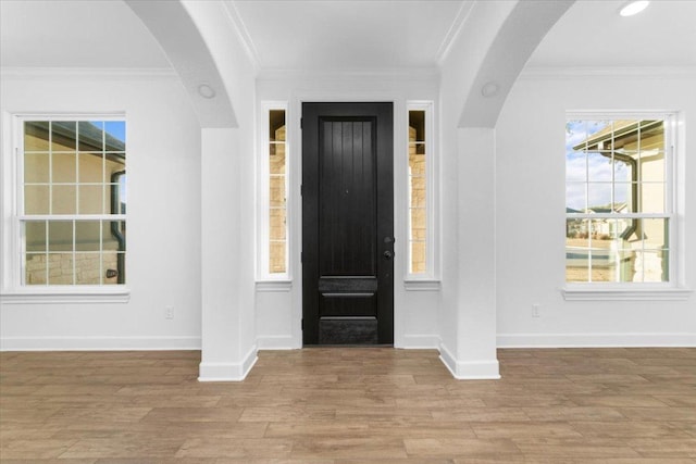 4121 Turning Leaf Dr, Nolanville, TX 76559 - entryway featuring light wood-style flooring, arched walkways, and crown molding