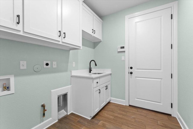 4121 Turning Leaf Dr, Nolanville, TX 76559 - laundry area featuring gas dryer hookup, electric dryer hookup, cabinet space, and wood finished floors