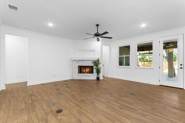 4121 Turning Leaf Dr, Nolanville, TX 76559 - unfurnished living room with ornamental molding, a ceiling fan, wood finished floors, a fireplace, and recessed lighting