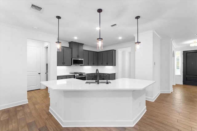 4121 Turning Leaf Dr, Nolanville, TX 76559 - kitchen with stainless steel appliances, backsplash, light countertops, wood finished floors, and ornamental molding
