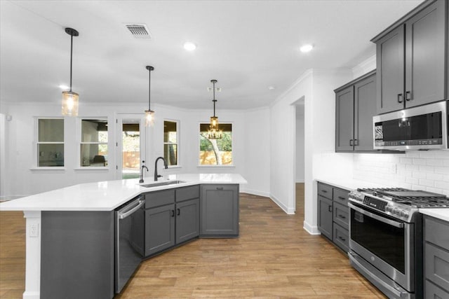 4121 Turning Leaf Dr, Nolanville, TX 76559 - kitchen with appliances with stainless steel finishes, light countertops, light wood finished floors, tasteful backsplash, and crown molding