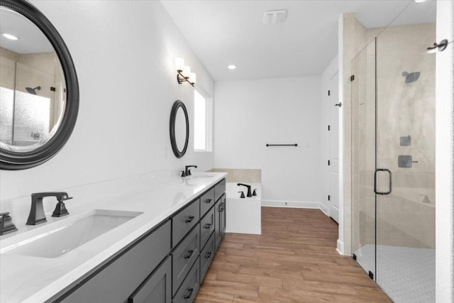 4121 Turning Leaf Dr, Nolanville, TX 76559 - full bath with wood finished floors, double vanity, a shower stall, and recessed lighting