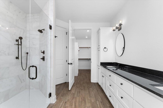 4113 Turning Leaf Dr, Nolanville, TX 76559 - bathroom with a stall shower, double vanity, wood finished floors, and a walk in closet