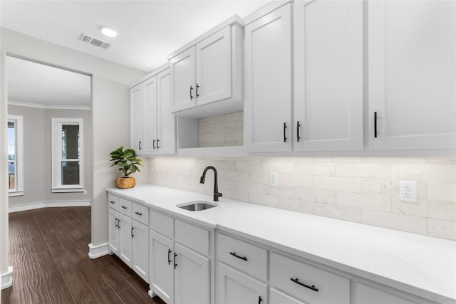 7026 Troyan, Temple, TX 76502 - kitchen featuring light countertops, white cabinetry, crown molding, and decorative backsplash