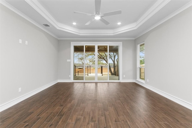 7026 Troyan, Temple, TX 76502 - empty room featuring a raised ceiling, ceiling fan, dark wood-style flooring, ornamental molding, and recessed lighting