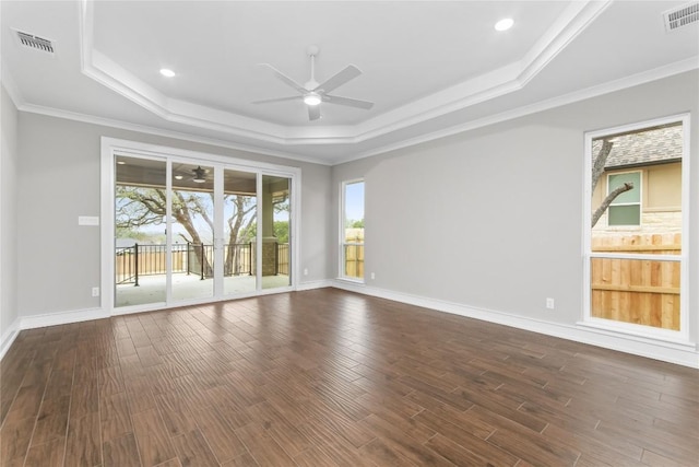 7026 Troyan, Temple, TX 76502 - empty room with ceiling fan, a tray ceiling, dark wood-style flooring, ornamental molding, and recessed lighting
