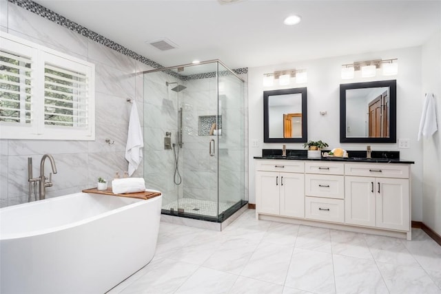 4604 Fawnwood Cv, Austin, TX 78735 - bathroom featuring double vanity, a stall shower, a freestanding bath, marble look tile flooring, and recessed lighting