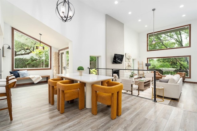 4604 Fawnwood Cv, Austin, TX 78735 - dining area featuring a towering ceiling, light wood-style flooring, and recessed lighting