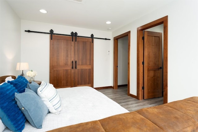 4604 Fawnwood Cv, Austin, TX 78735 - bedroom with wood finished floors, recessed lighting, and a barn door