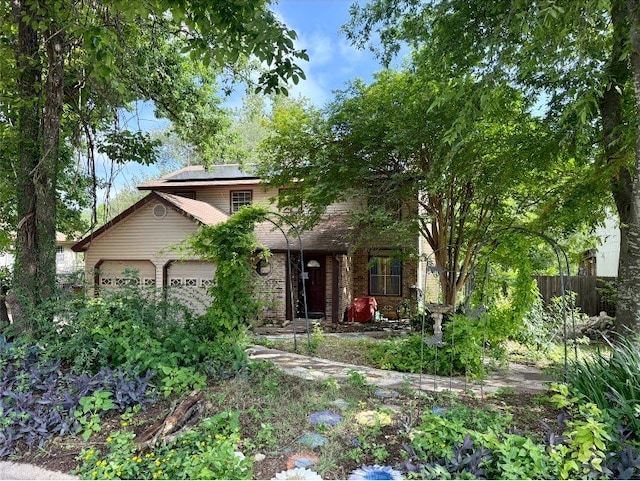 8306 Hanbridge Ln, Austin, TX 78736 - obstructed view of property with roof mounted solar panels and an attached garage