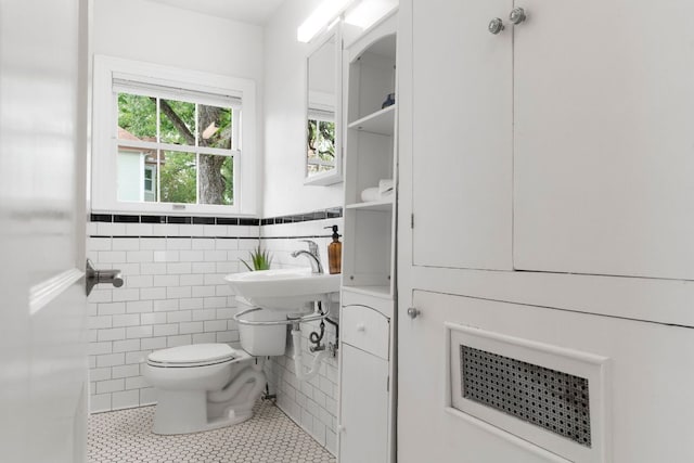 502 E 46th St, Austin, TX 78751 - bathroom with tile walls, tile patterned floors, and wainscoting