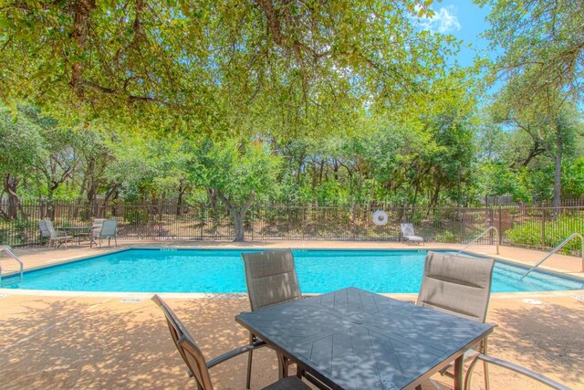 3300 Forest Creek Dr Unit 45, Round Rock, TX 78664 - community pool featuring a fenced backyard, a patio area, outdoor dining area, and view of wooded area
