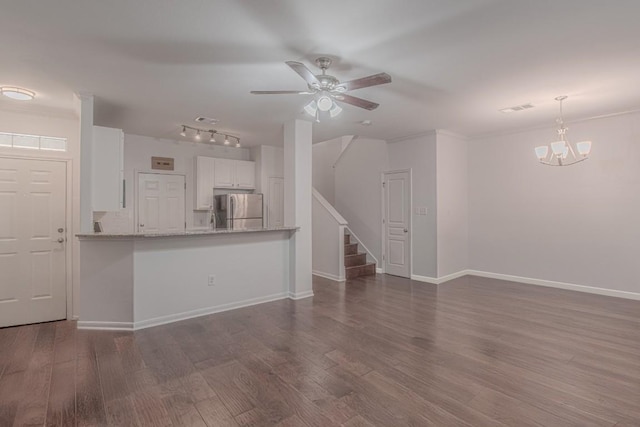 3300 Forest Creek Dr Unit 45, Round Rock, TX 78664 - unfurnished living room with stairs, a ceiling fan, wood finished floors, a chandelier, and rail lighting