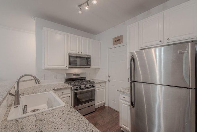 3300 Forest Creek Dr Unit 45, Round Rock, TX 78664 - kitchen featuring appliances with stainless steel finishes, white cabinets, backsplash, dark wood-style flooring, and light stone counters