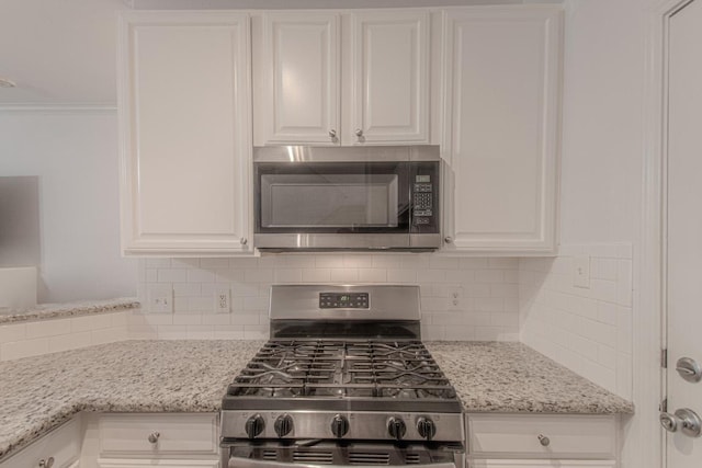 3300 Forest Creek Dr Unit 45, Round Rock, TX 78664 - kitchen view of appliances with stainless steel finishes, white cabinets, tasteful backsplash, and crown molding
