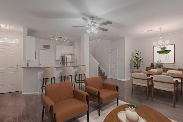 3300 Forest Creek Dr Unit 45, Round Rock, TX 78664 - living area featuring stairs, wood finished floors, a ceiling fan, track lighting, and a chandelier