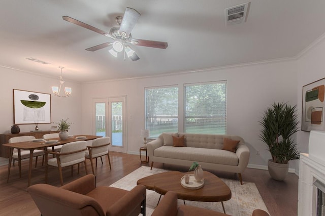 3300 Forest Creek Dr Unit 45, Round Rock, TX 78664 - living room with ornamental molding, light wood finished floors, ceiling fan, and a chandelier