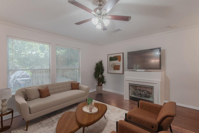3300 Forest Creek Dr Unit 45, Round Rock, TX 78664 - living area featuring ceiling fan, wood finished floors, ornamental molding, and a fireplace