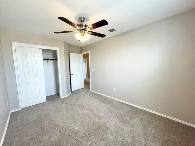 139 Diamondback Cv, Buda, TX 78610 - unfurnished bedroom with carpet, a closet, and a ceiling fan